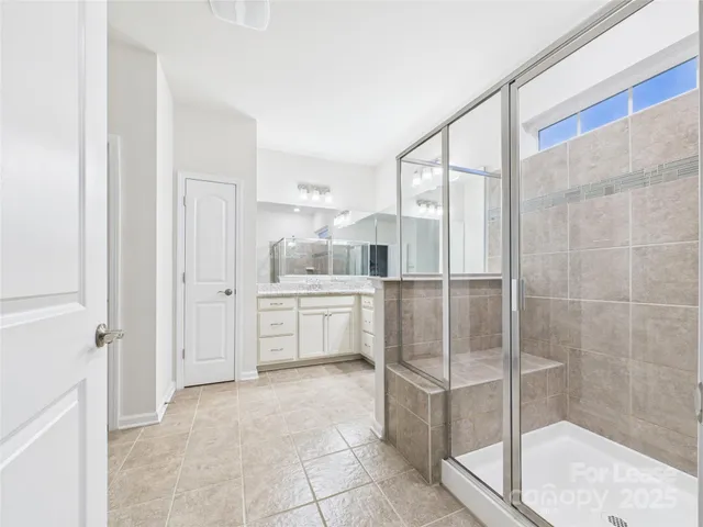 a bathroom with a shower and a sink