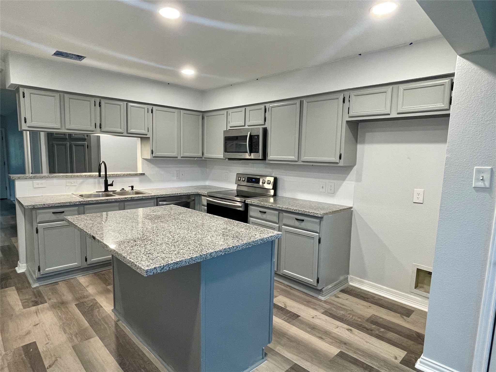 1225 Clover Drive Angleton, TX 77515 - Photo 3 of 15 a kitchen with a sink stove and refrigerator