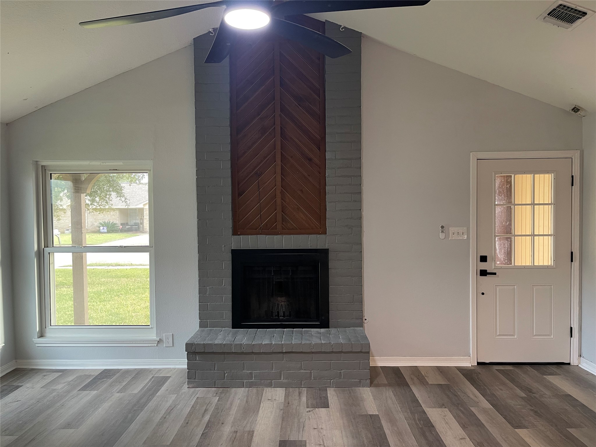 1225 Clover Drive Angleton, TX 77515 - Photo 5 of 15 a view of an empty room with wooden floor and a window