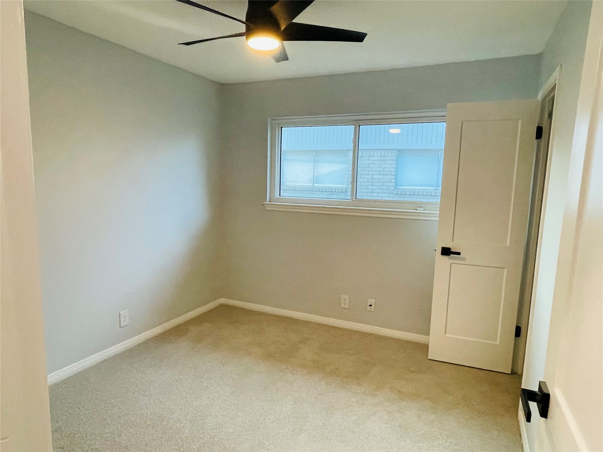 1225 Clover Drive Angleton, TX 77515 - Photo 9 of 15 an empty room with a window and a ceiling fan
