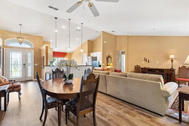 a dining room with furniture and wooden floor