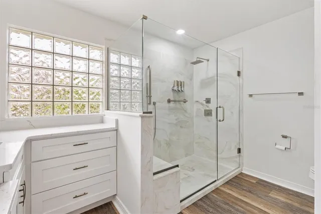 a bathroom with a shower and a sink