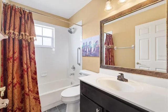 a bathroom with a sink a toilet and a large mirror