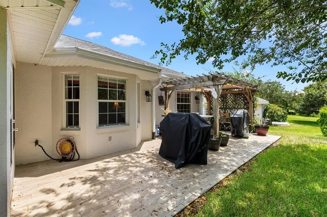 a view of a house with backyard and sitting area
