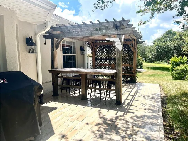 a view of a house with backyard and sitting area