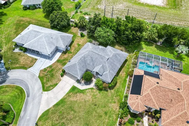 an aerial view of a house with garden space and street view