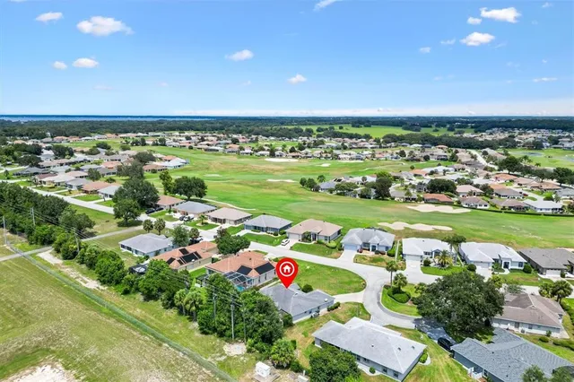 an aerial view of a city with lots of residential buildings and green space