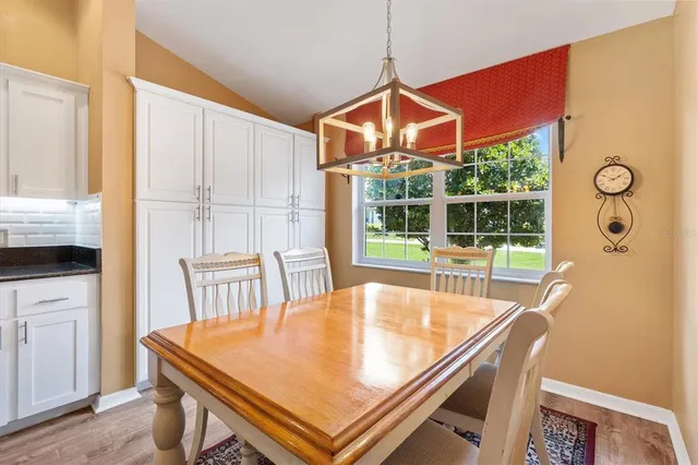 a dining room with furniture and window