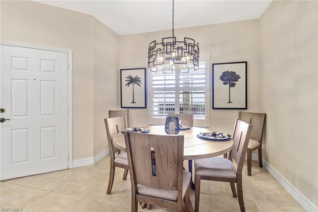 401 Bayfront Place, Unit 3205 Naples, FL 34102 - Photo 11 of 35 a view of a dining room with furniture window and chandelier