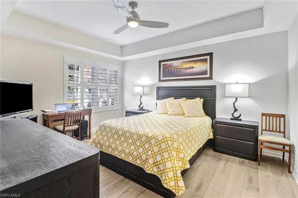 a bedroom with bed and a flat screen tv