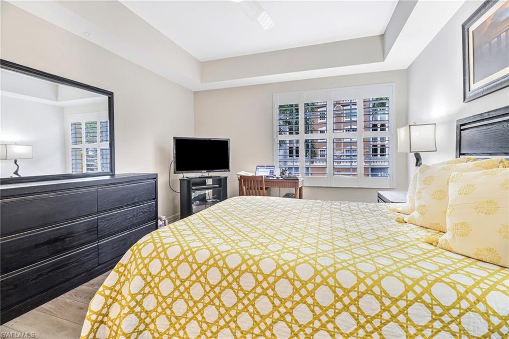 401 Bayfront Place, Unit 3205 Naples, FL 34102 - Photo 15 of 35 a bedroom with a bed and a television