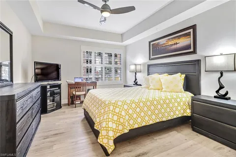 a bed room with a bed and a television