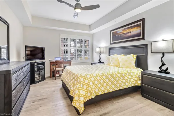 a bed room with a bed and a television