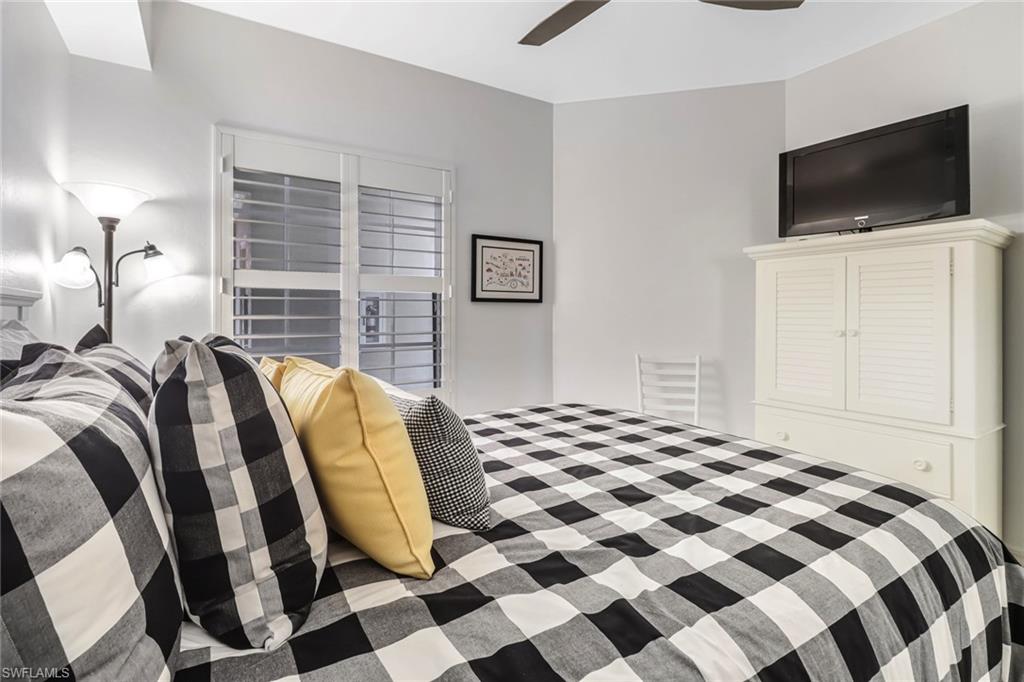 401 Bayfront Place, Unit 3205 Naples, FL 34102 - Photo 19 of 35 a bedroom with a bed and a flat screen tv