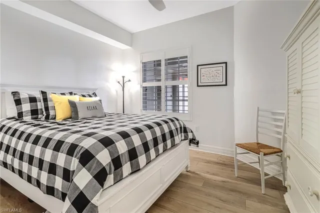 a bedroom with a large bed and a window