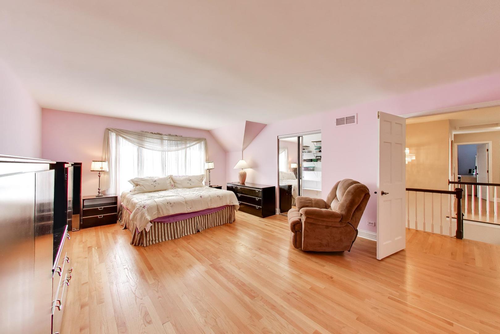 766 Camelot Drive Burr Ridge, IL 60527 - Photo 18 of 48 a spacious bedroom with a bed and wooden floor