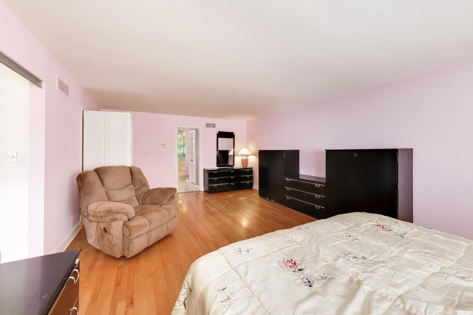 766 Camelot Drive Burr Ridge, IL 60527 - Photo 19 of 48 a bedroom with a bed and dresser with mirror