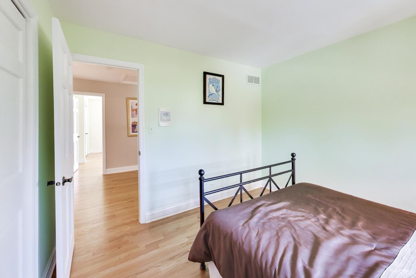 766 Camelot Drive Burr Ridge, IL 60527 - Photo 24 of 48 a bedroom with a bed and wooden floor