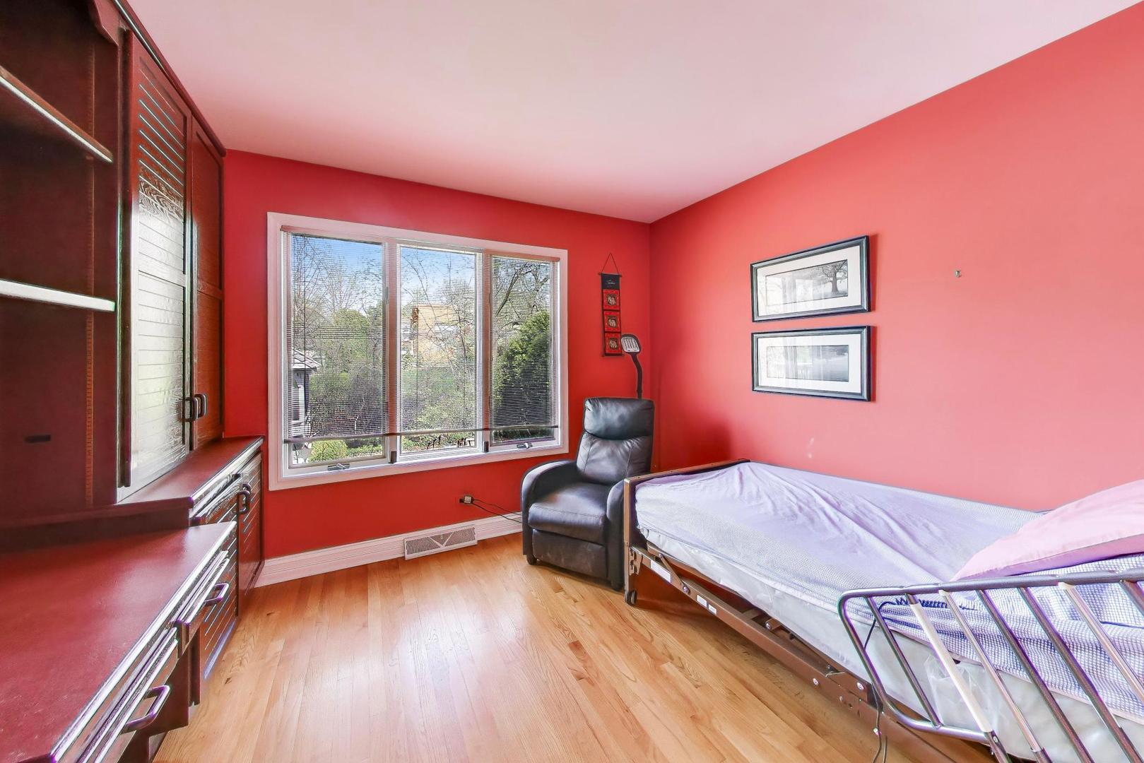 766 Camelot Drive Burr Ridge, IL 60527 - Photo 28 of 48 a bedroom with a bed and a large window with wooden floor