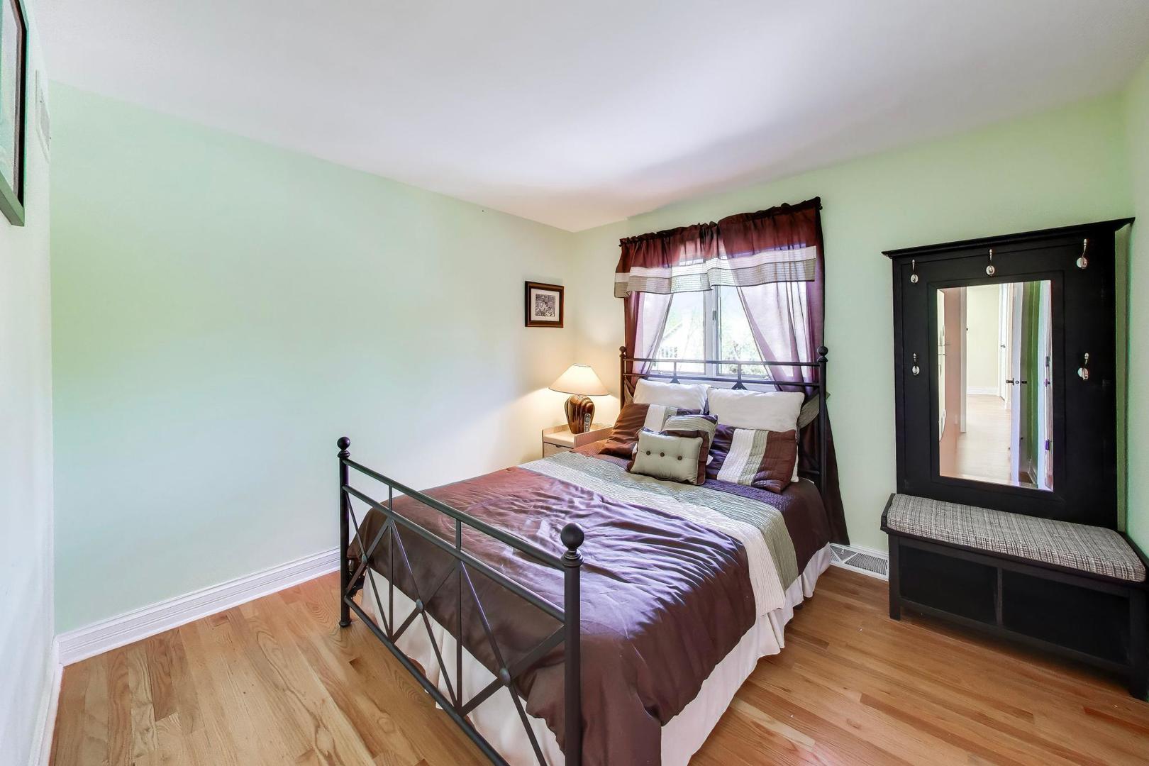 766 Camelot Drive Burr Ridge, IL 60527 - Photo 29 of 48 a bedroom with a bed and wooden floor