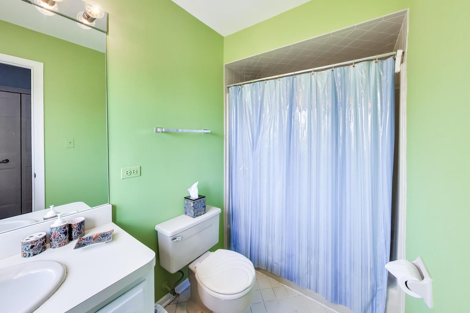 766 Camelot Drive Burr Ridge, IL 60527 - Photo 33 of 48 a bathroom with a sink a toilet and shower curtain