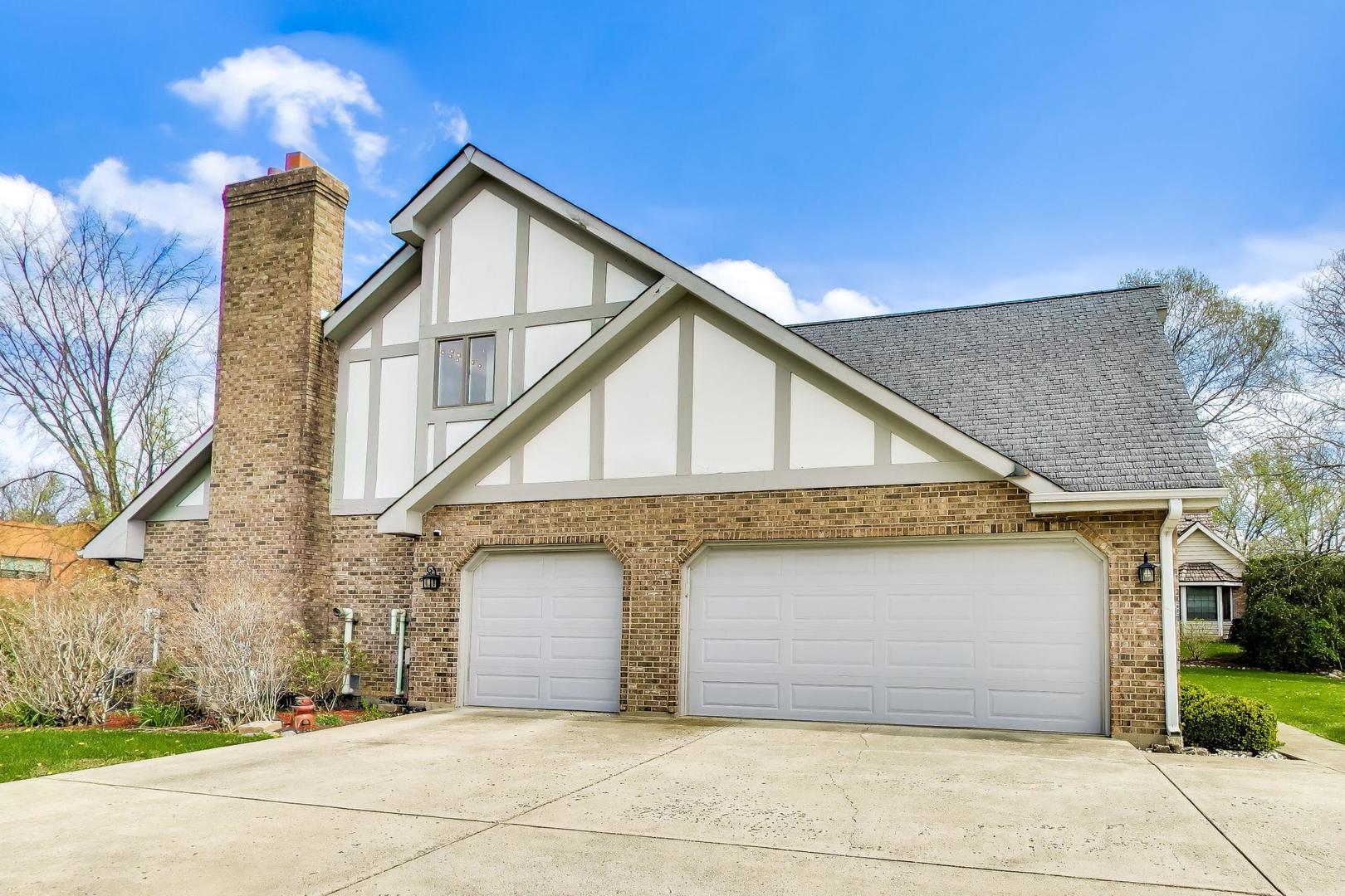 766 Camelot Drive Burr Ridge, IL 60527 - Photo 5 of 48 a front view of a house with a yard and garage
