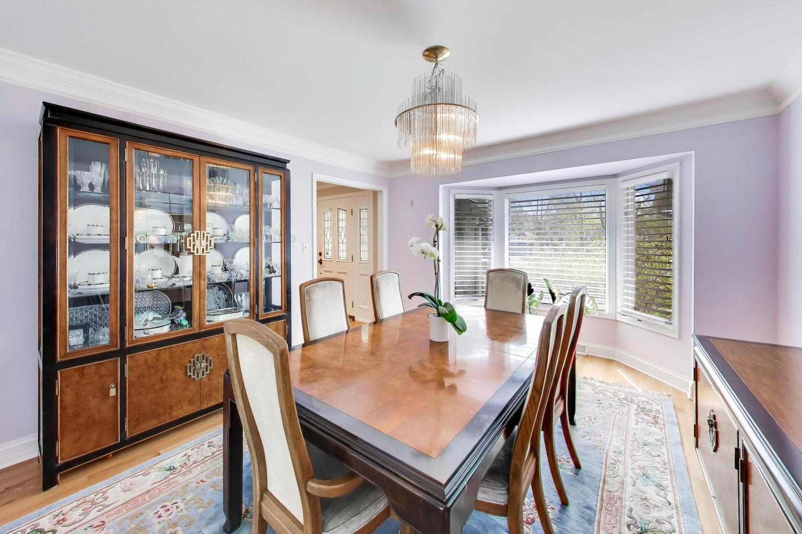 766 Camelot Drive Burr Ridge, IL 60527 - Photo 6 of 48 a view of a dining room with furniture a chandelier and wooden floor