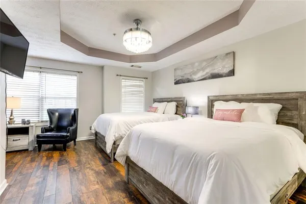 a bedroom with bed and flat tv