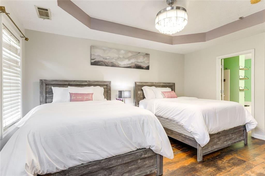 3840 Augustine Place Rex, GA 30273 - Photo 12 of 23 a bedroom with two beds and a chandelier
