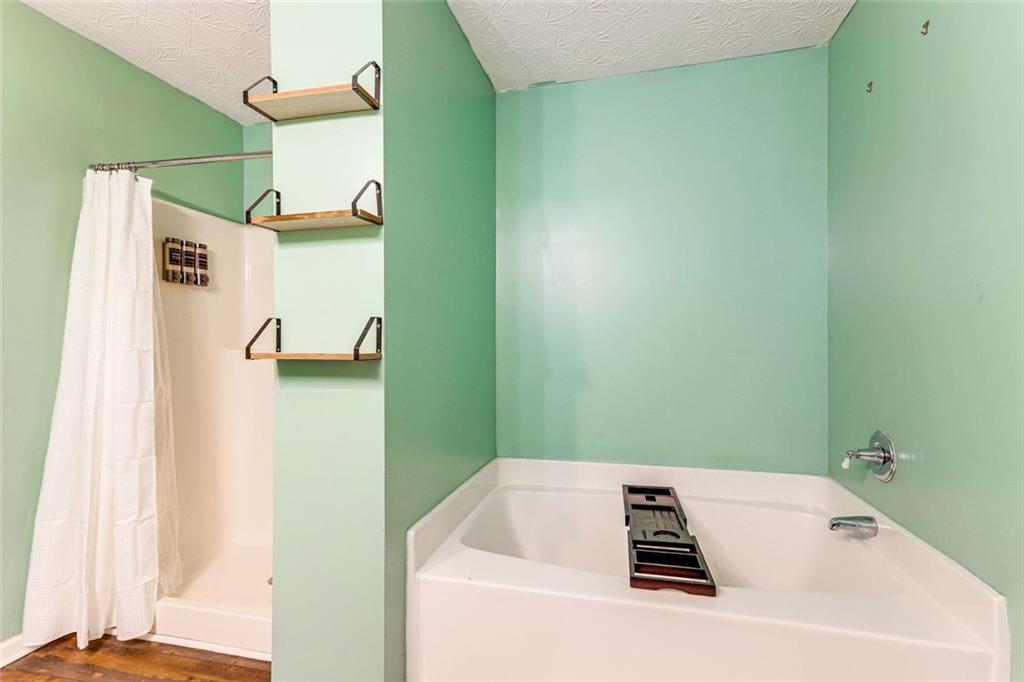 3840 Augustine Place Rex, GA 30273 - Photo 15 of 23 a bathroom with a bathtub and a shower