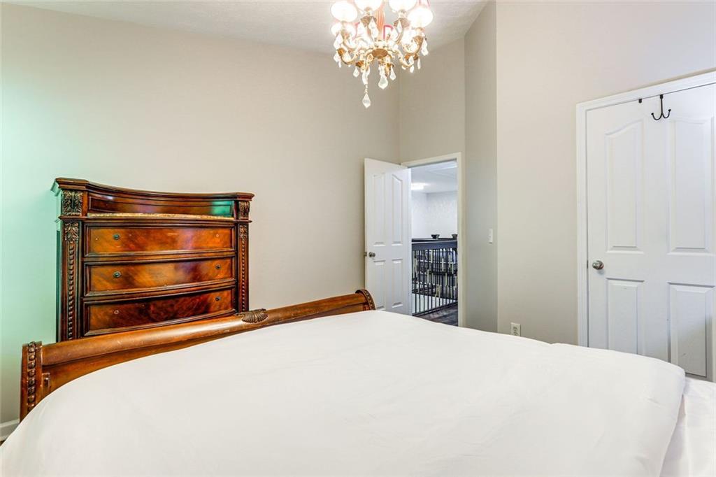 3840 Augustine Place Rex, GA 30273 - Photo 17 of 23 a bedroom with a bed and a chandelier