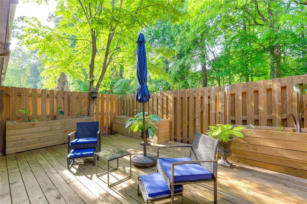 3840 Augustine Place Rex, GA 30273 - Photo 20 of 23 a backyard of a house with dining table and chairs with wooden fence
