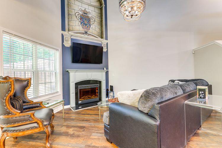 3840 Augustine Place Rex, GA 30273 - Photo 2 of 23 a living room with furniture a flat screen tv and a fireplace