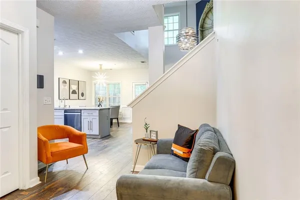 a living room with furniture and a chandelier