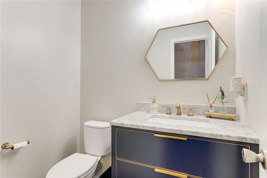 3840 Augustine Place Rex, GA 30273 - Photo 9 of 23 a bathroom with a toilet sink and mirror