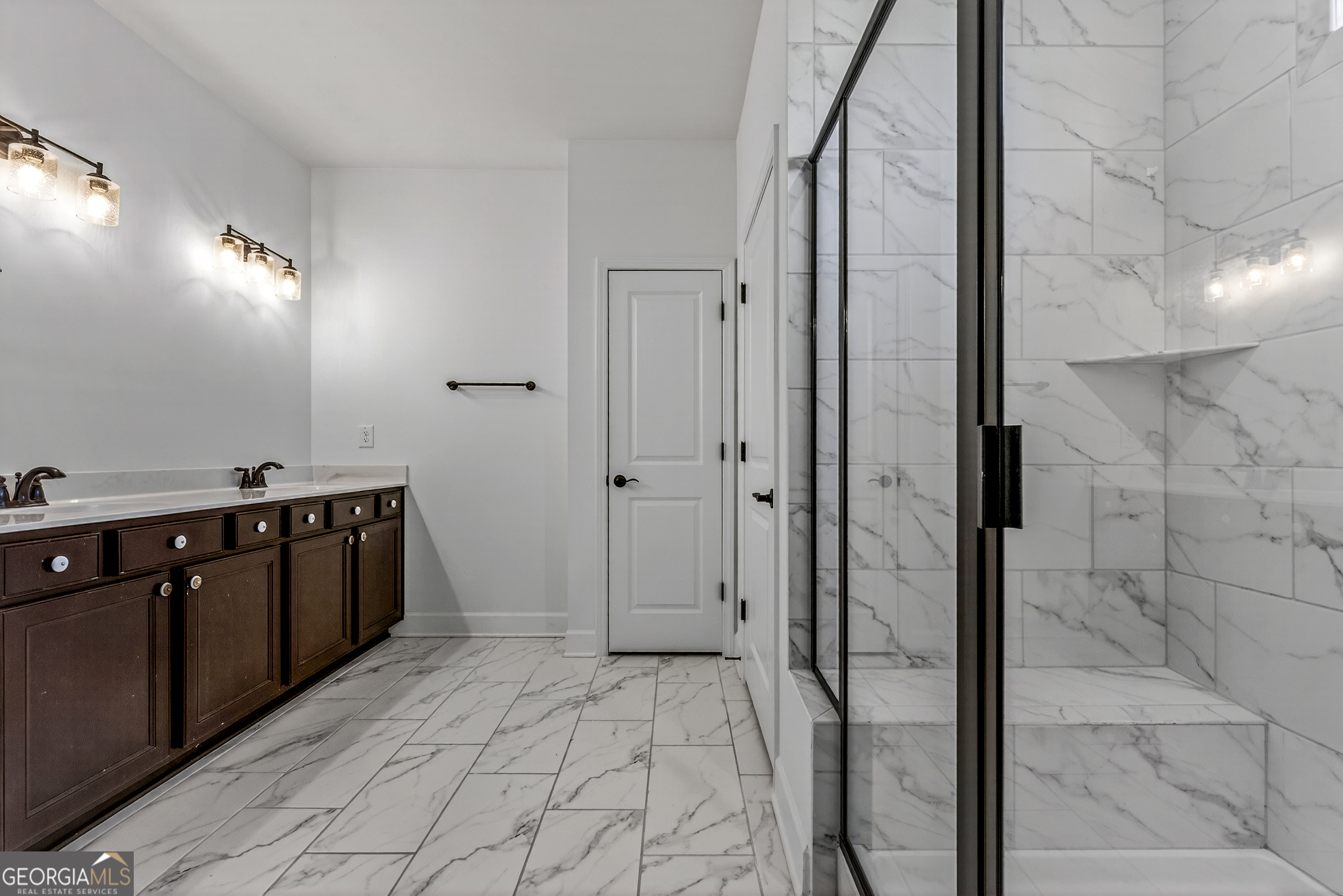 1060 Lone Oak Road Greensboro, GA 30642 - Photo 19 of 26 a spacious bathroom with a double vanity sink a mirror and a shower