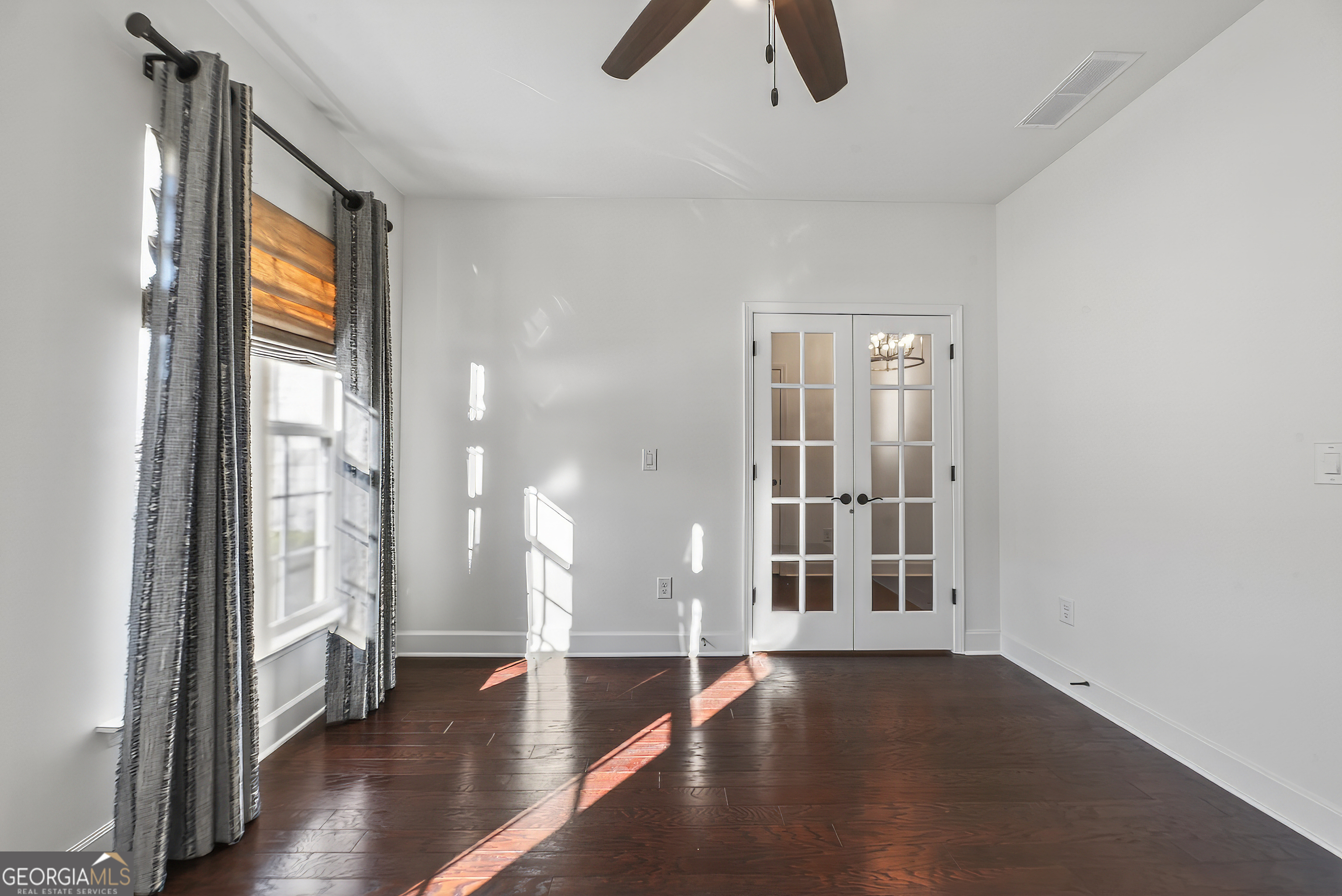 1060 Lone Oak Road Greensboro, GA 30642 - Photo 23 of 26 an empty room with wooden floor and windows