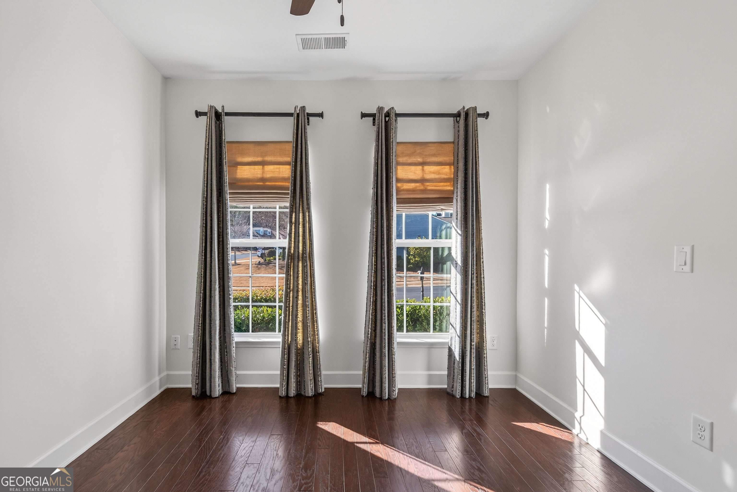 1060 Lone Oak Road Greensboro, GA 30642 - Photo 24 of 26 an empty room with wooden floor and windows