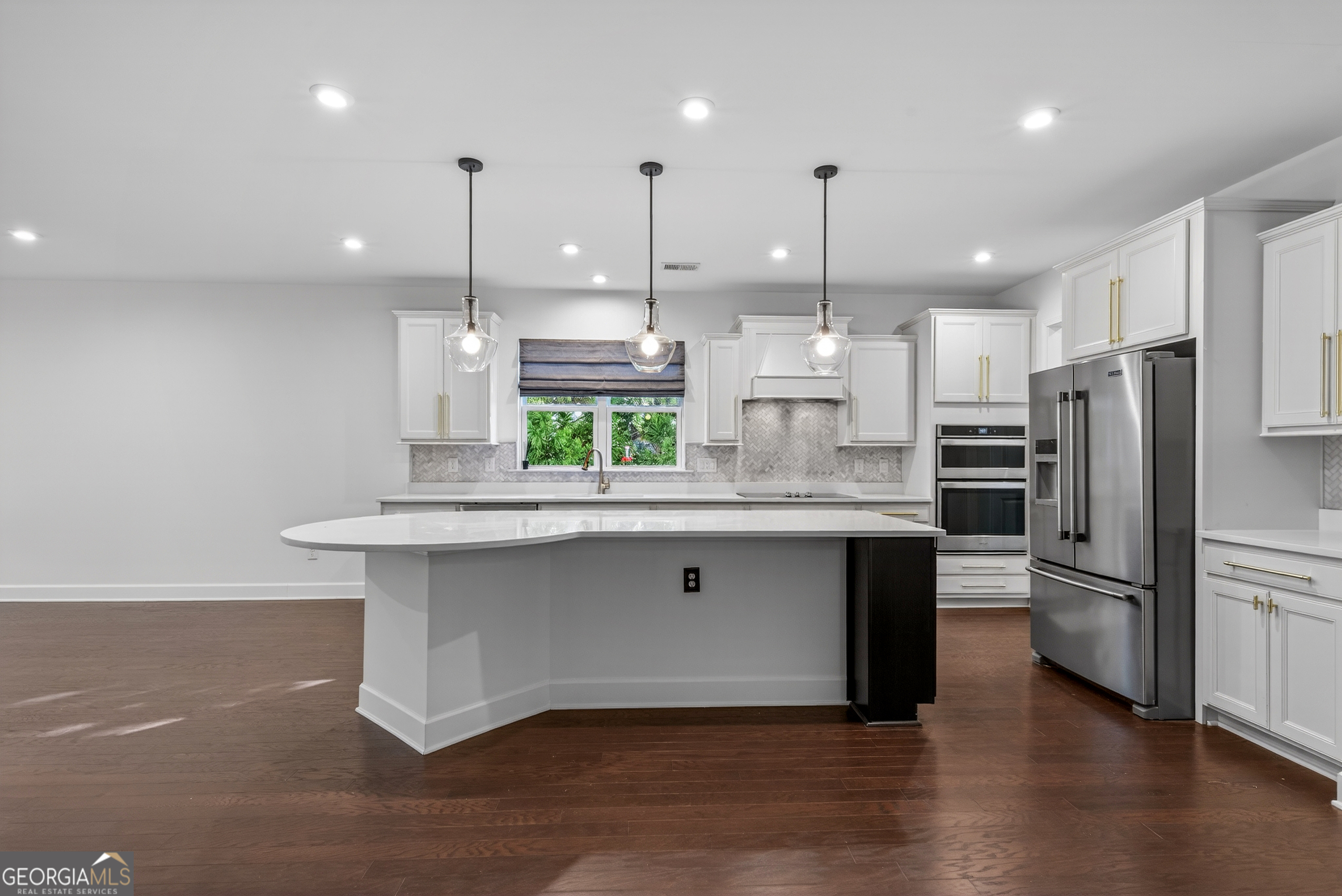 1060 Lone Oak Road Greensboro, GA 30642 - Photo 8 of 26 a kitchen with stainless steel appliances granite countertop a sink a refrigerator and a stove top oven with wooden floor