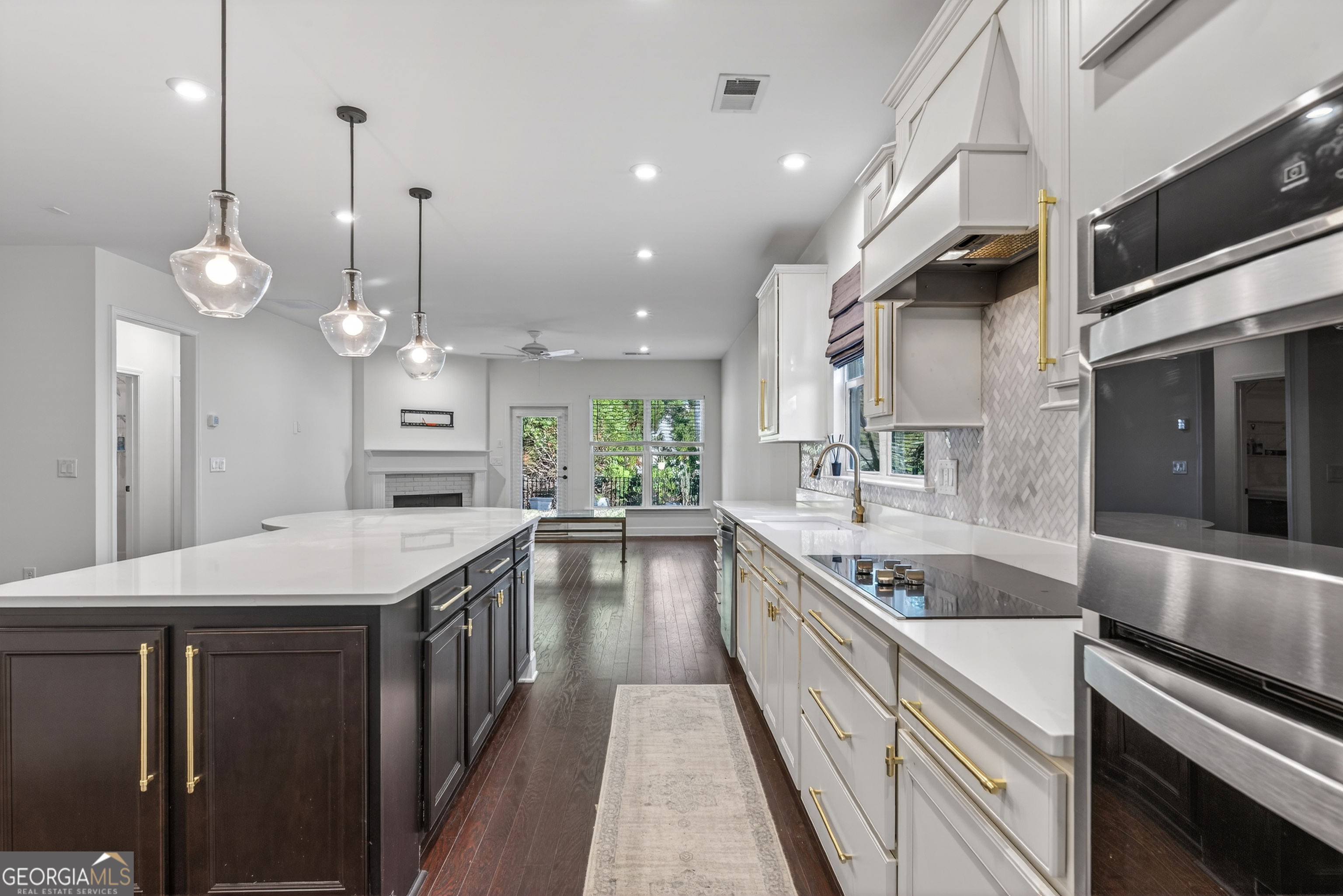 1060 Lone Oak Road Greensboro, GA 30642 - Photo 9 of 26 a large kitchen with stainless steel appliances kitchen island a large island in the center