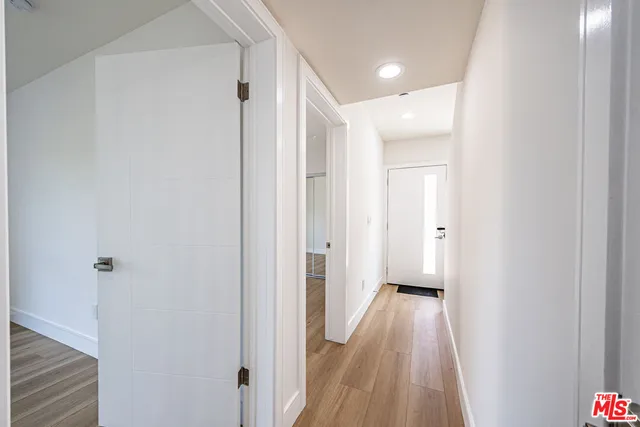 a view of a hallway with wooden floor