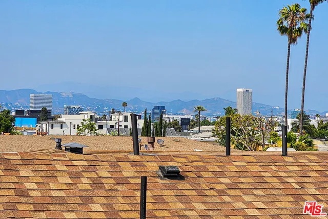 a view of a terrace with wooden floor and city view
