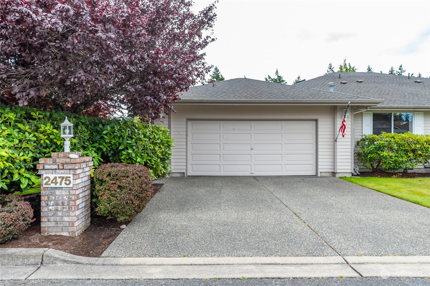 2475 Southwest Talon Loop Oak Harbor, WA 98277 - Photo 1 of 27 a front view of a house with garden