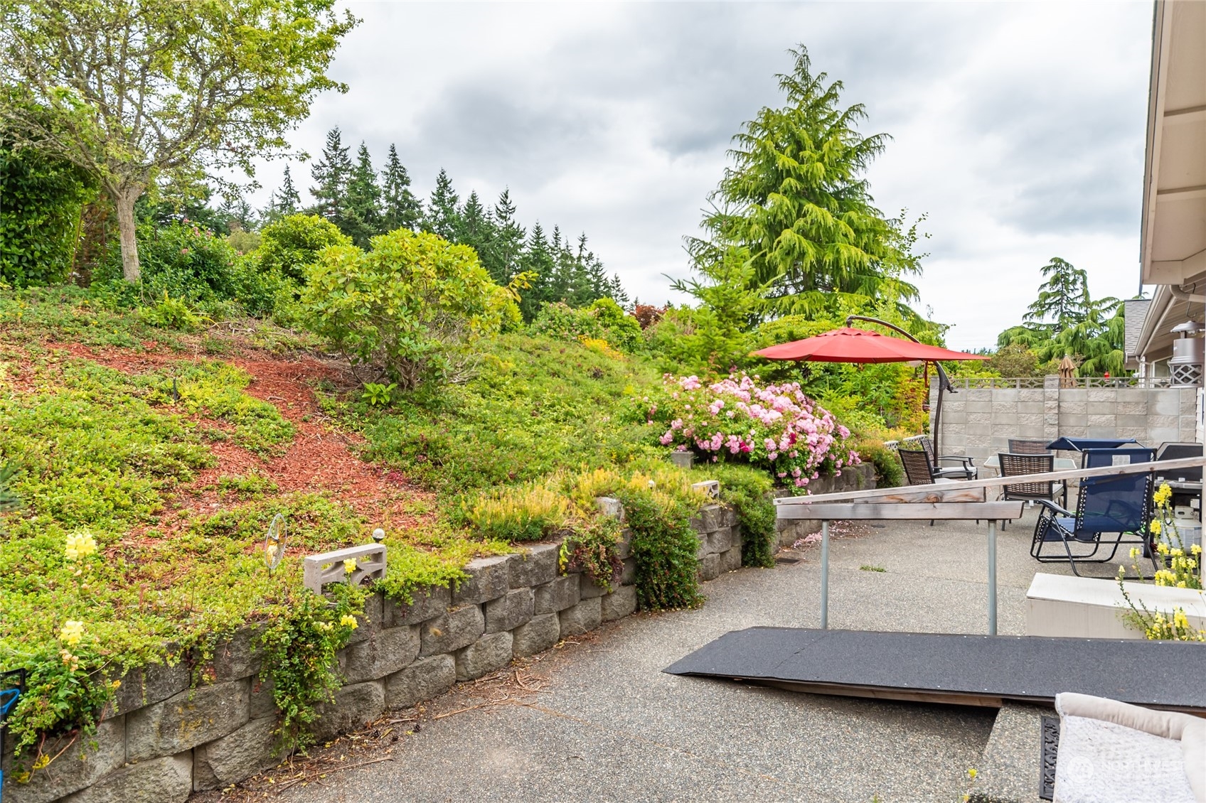 2475 Southwest Talon Loop Oak Harbor, WA 98277 - Photo 27 of 27 a view of backyard with a patio and plants