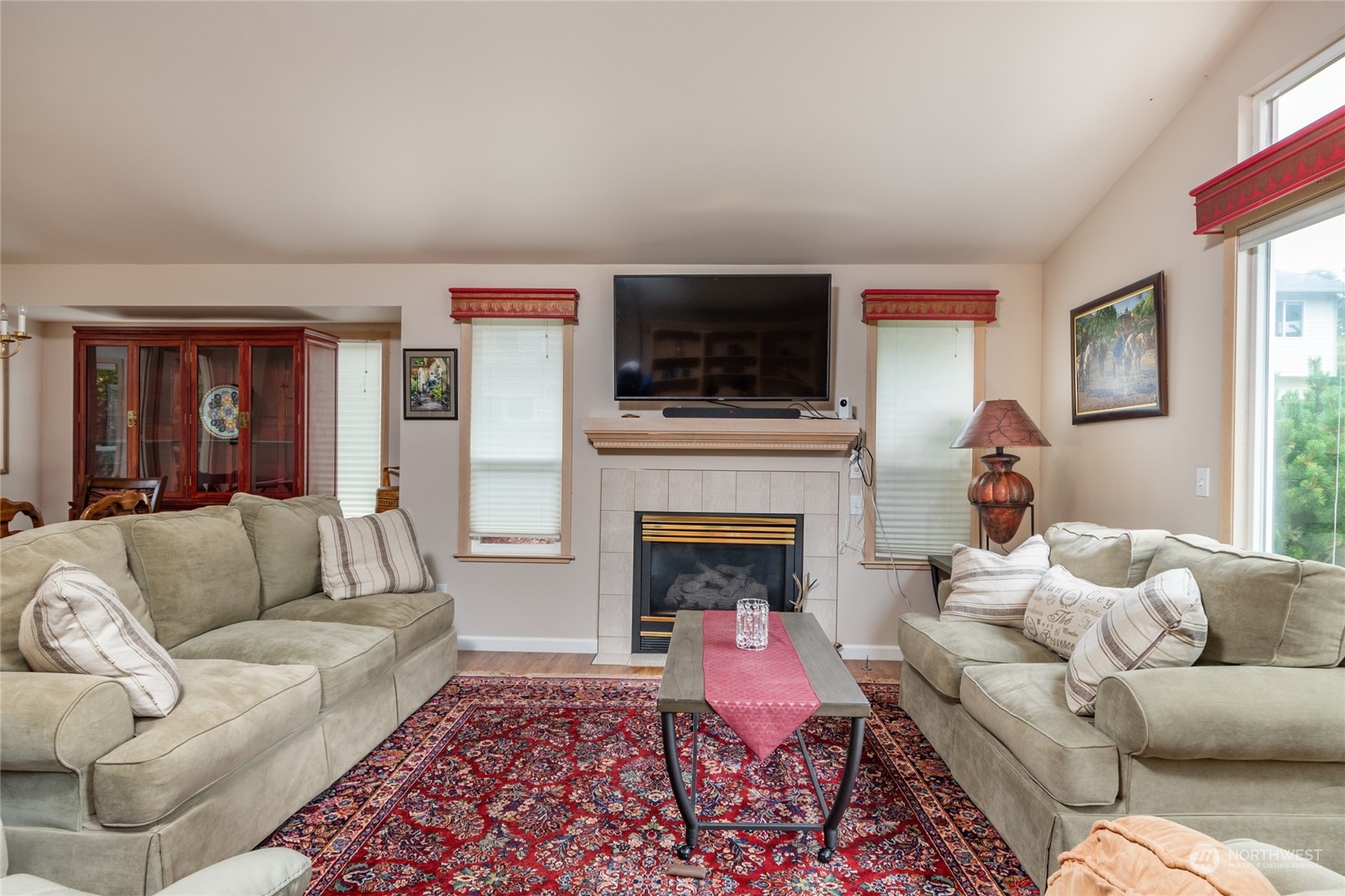 2475 Southwest Talon Loop Oak Harbor, WA 98277 - Photo 5 of 27 a living room with furniture a flat screen tv and a fireplace