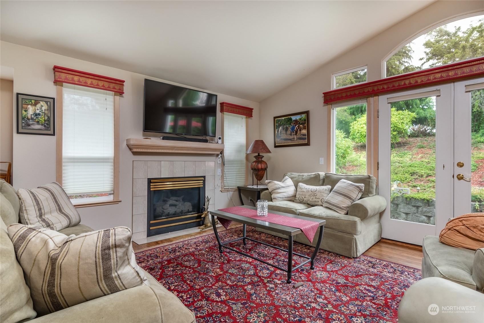 2475 Southwest Talon Loop Oak Harbor, WA 98277 - Photo 6 of 27 a living room with furniture a flat screen tv and a fireplace