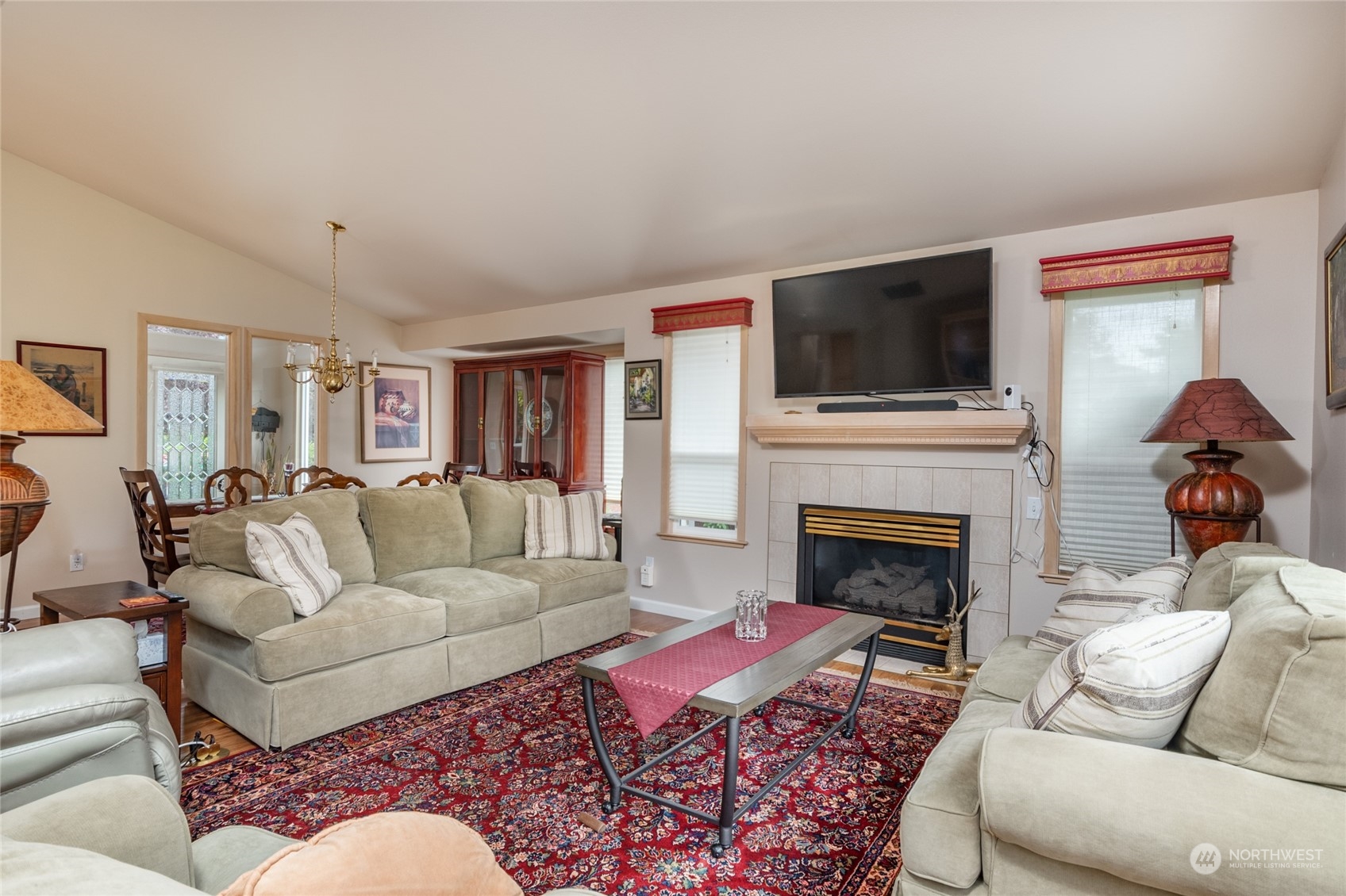 2475 Southwest Talon Loop Oak Harbor, WA 98277 - Photo 7 of 27 a living room with furniture a flat screen tv and a fireplace
