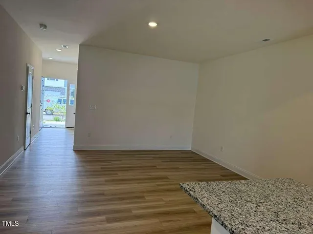 a view of an empty room and wooden floor