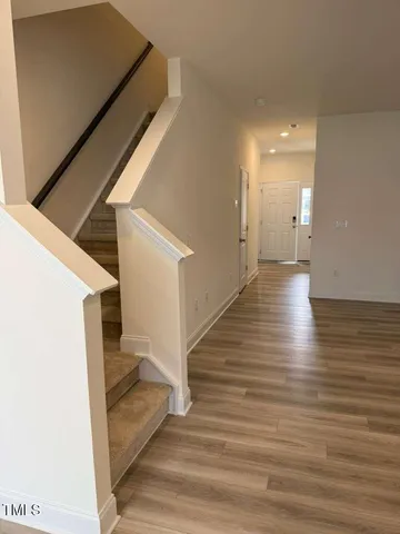 a view of a hallway view with wooden floor and staircase