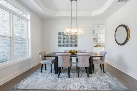 a view of a dining room with furniture and chandelier